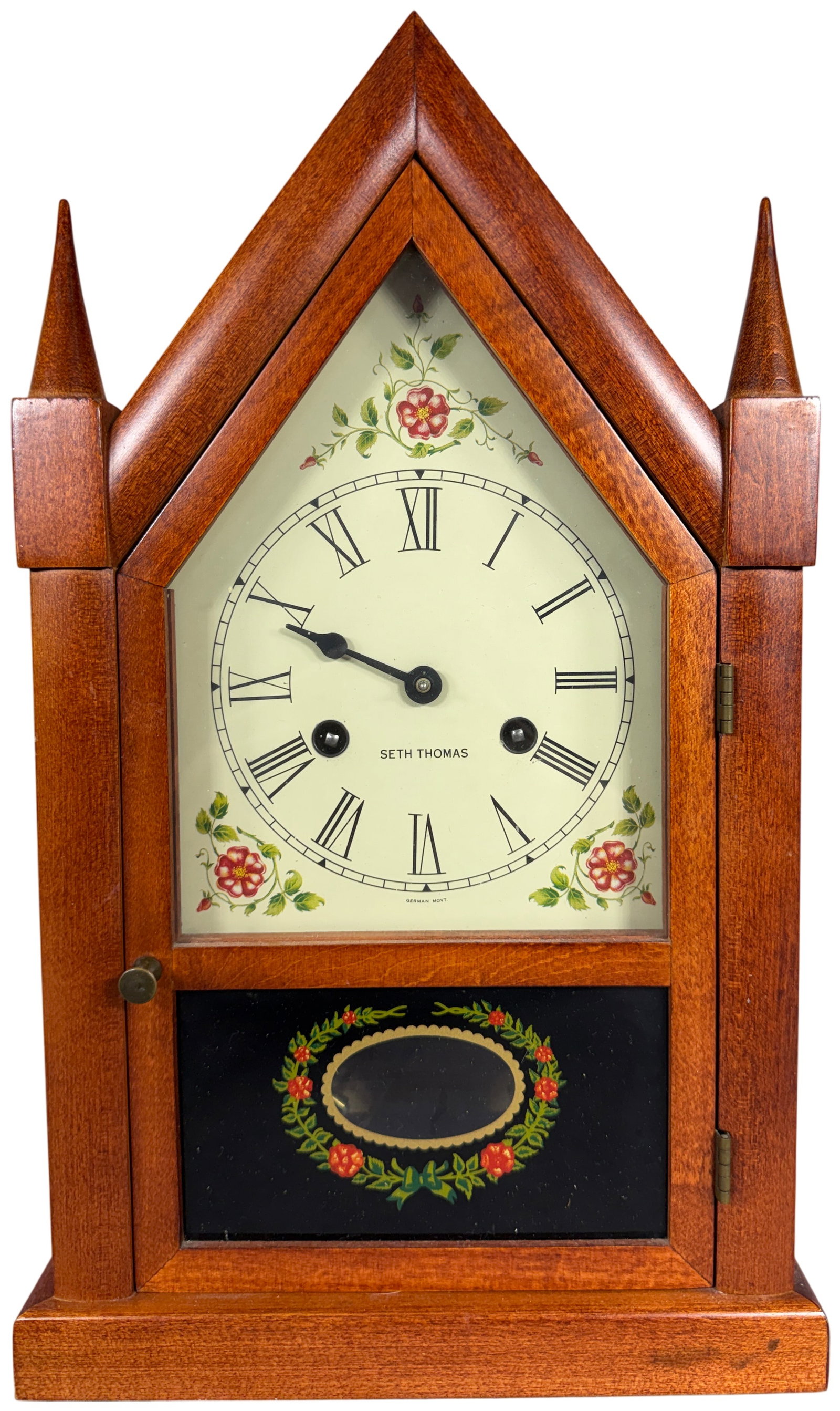 Seth Thomas Sharon-10W Steeple Mantel Clock: A vintage Seth Thomas steeple-style mantel clock, model Sharon-10W. The wooden case features a characteristic pointed steeple top flanked by two turned finials and is finished in a warm reddish-brown 