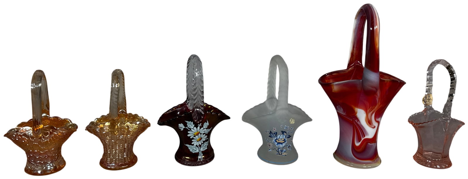 An Assortment of American Art Glass Baskets including Imperial and Westmoreland: A collection of six decorative glass baskets in various colors and techniques. The group includes an Imperial Glass Corporation ruby slag glass basket with red and white marbled swirls, featuring a fl