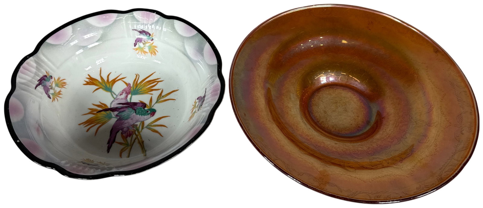 Two Decorative Bowls Comprising a German Art Deco Porcelain Bowl and a Marigold Carnival Glass Dish: A group of two decorative bowls. The first is a German porcelain serving bowl from the Art Deco period, featuring a scalloped and fluted rim highlighted with a black border and pink sponged petal moti