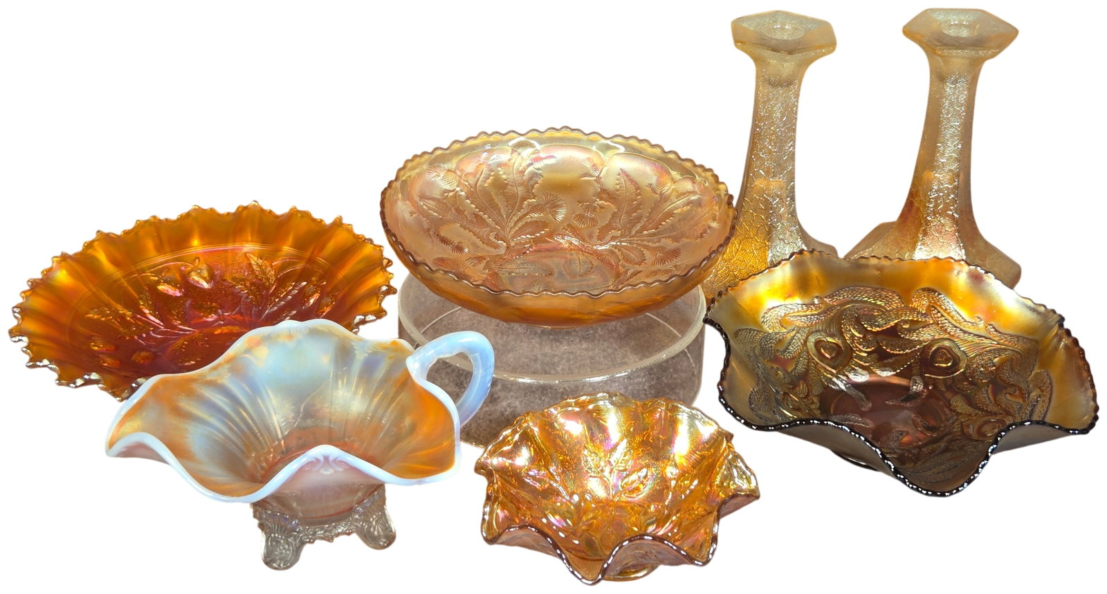 Seven Piece Collection of American Carnival Glass Including Northwood, Fenton, and Imperial Glass: A seven piece collection of American carnival glass featuring Northwood, Fenton, and Imperial Glass patterns. This group includes an amethyst glass bowl in the Peacock at the Urn pattern with a ruffle