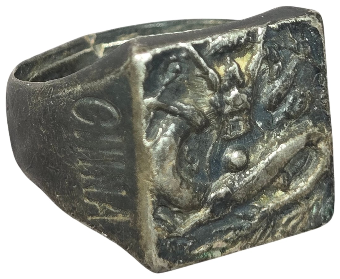 Chinese Export Dragon Signet Ring with Adjustable Shank: This vintage signet-style ring is crafted from a silver-tone metal, characteristic of Chinese export jewelry. The rectangular face features a cast, high-relief depiction of a traditional Chinese drago