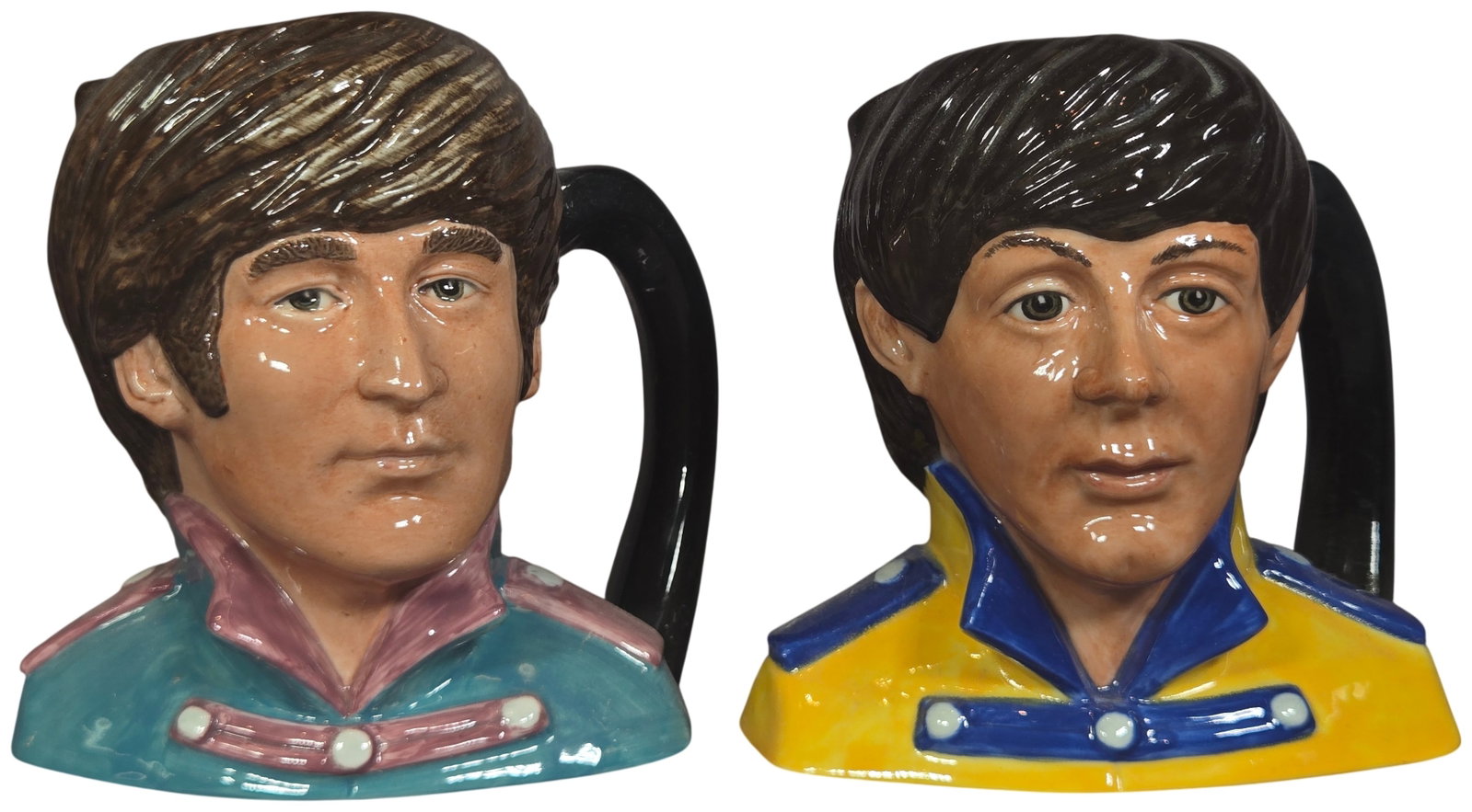 A Pair of Royal Doulton Ceramic The Beatles Character Jugs Sgt. Pepper Series: A pair of ceramic character jugs produced by Royal Doulton as part of The Beatles series, issued in 1984. These pieces depict John Lennon and Paul McCartney in their Sgt. Pepper's Lonely Hearts Club B
