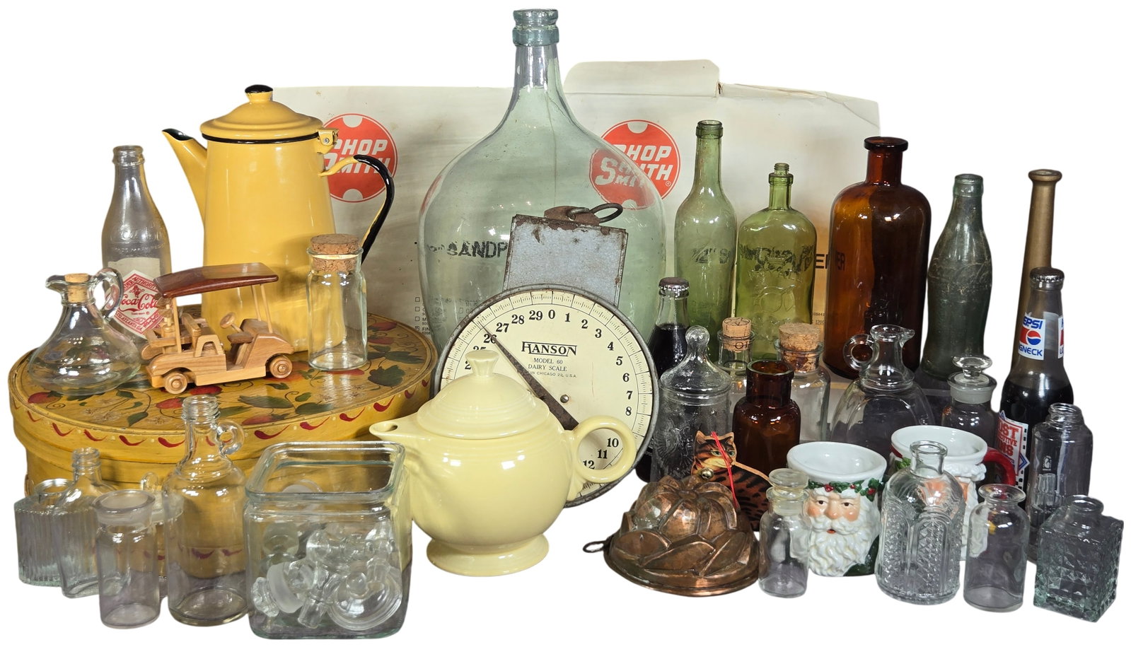 An Assortment of Vintage Household, Advertising, and Industrial Collectibles featuring a Hanson: An assortment of mid-20th-century household, advertising, and industrial items. The collection is anchored by a Hanson Model 60 Dairy Scale, constructed of metal with a capacity of 60 lbs and marked M