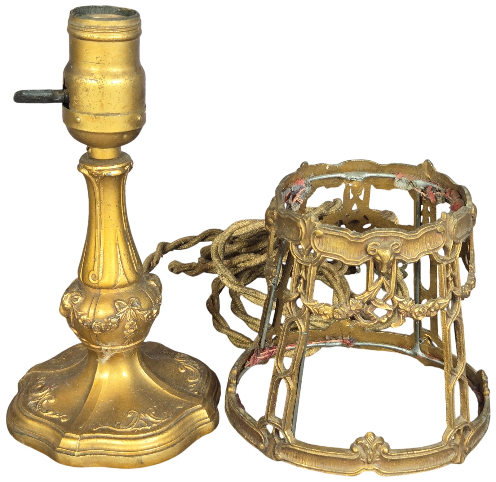 Antique Neo-Classical Gilt Metal Table Lamp with Matching Shade Frame: An ornate table lamp featuring a matching detached shade frame, both constructed from cast metal with a gold-toned finish. The base and frame are decorated in a Neo-Classical style with motifs includi