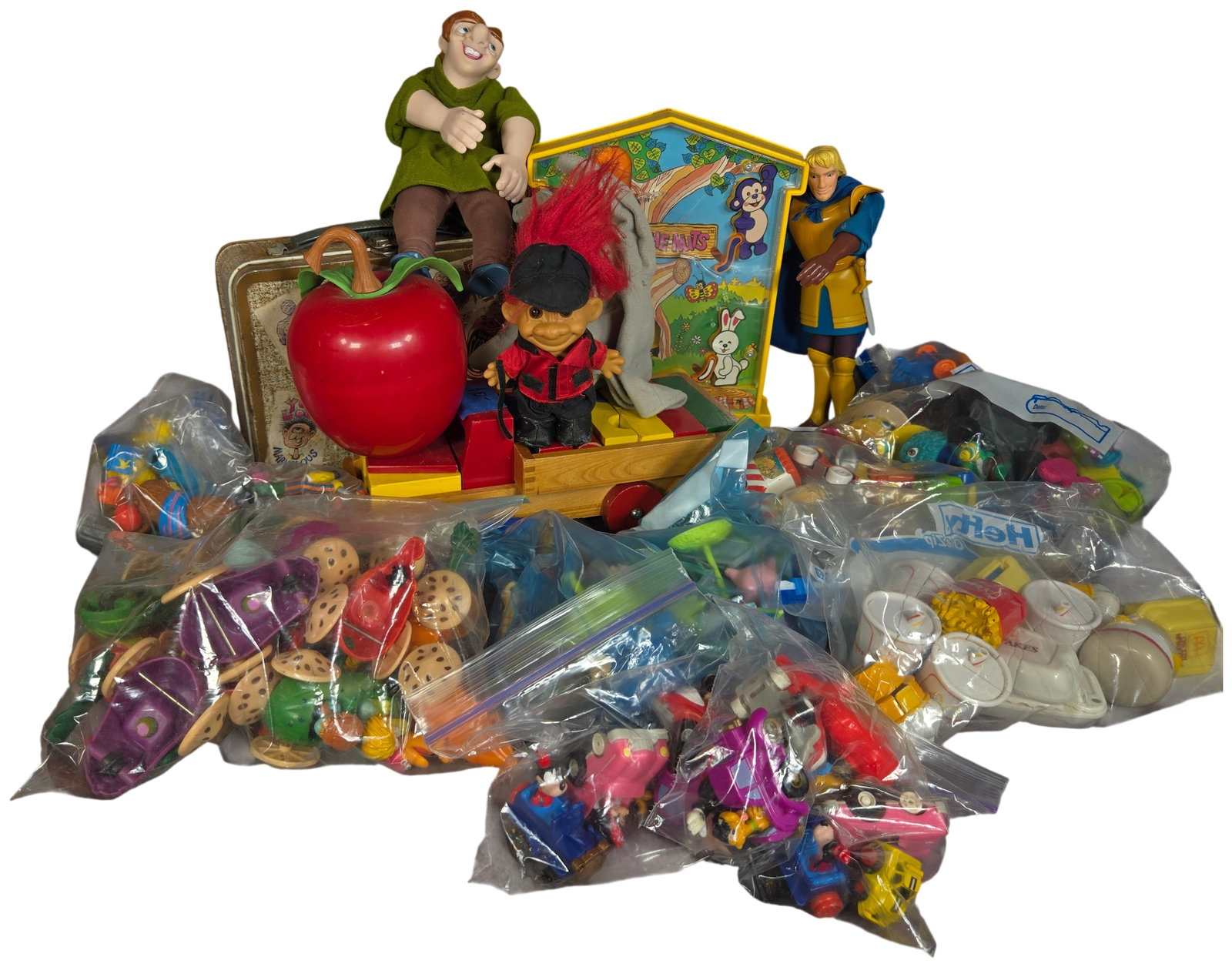 A Large Collection of Vintage Toys Including Fisher-Price Happy Apple, Disney Burger King Premiums,: This large assortment contains various vintage toys primarily dating from the 1970s through the 1990s. A primary item is a 1972 Fisher-Price Happy Apple chime toy, model number 435, constructed of red