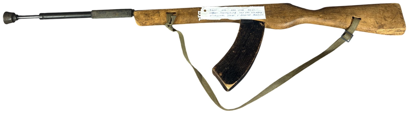 East German NVA Wooden AK-47 Bayonet Training Rifle with Sling: This East German National Peoples Army training rifle is constructed of carved wood and metal, designed for bayonet and close-quarters combat instruction. The rifle is carved to approximate the