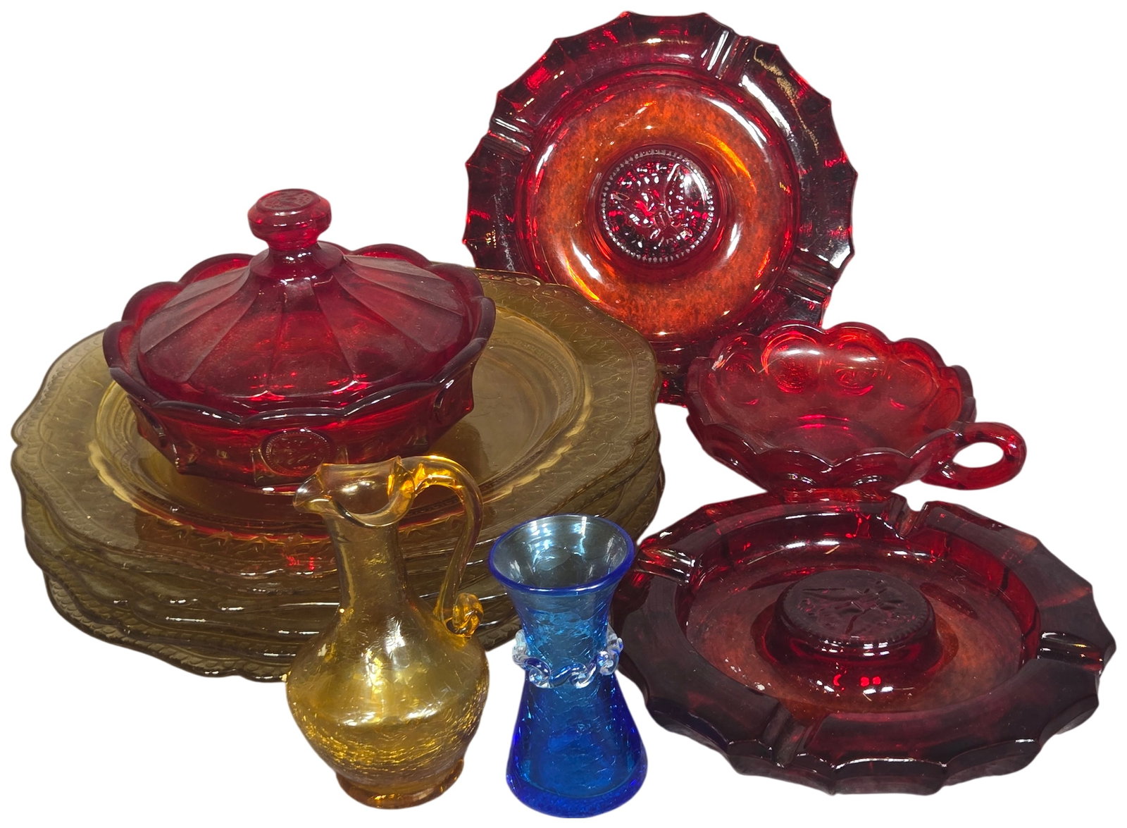 An Assortment of American Pressed and Hand Blown Glass including Fostoria Coin and Federal Patrician: A collection of vintage American glass featuring a variety of styles from the Depression era to the mid-century modern period. The group includes several pieces of ruby red pressed glass in the Fostor