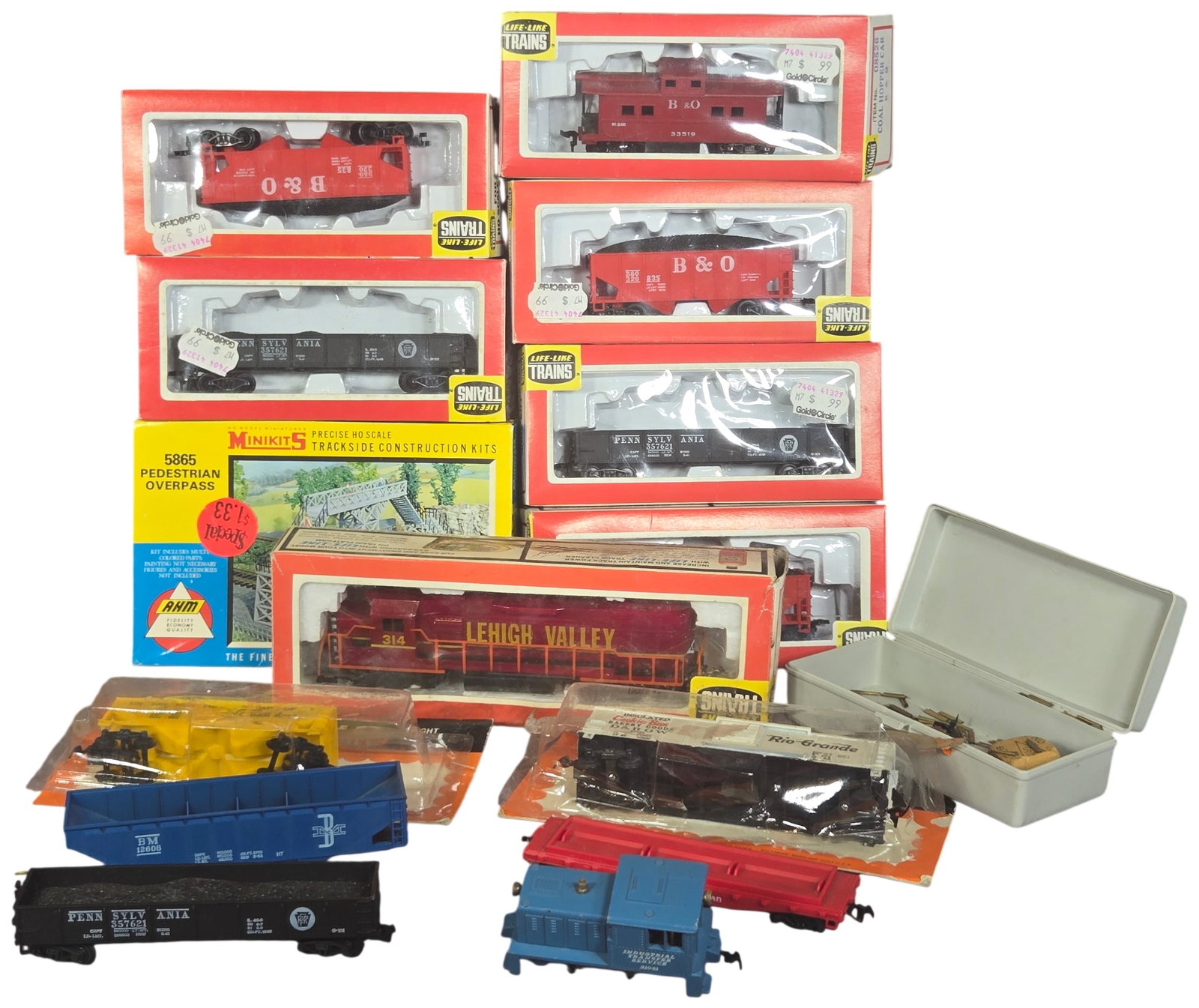 A Collection of Vintage HO Scale Model Trains and Accessories by Life-Like and AHM: This collection of HO scale model railroading equipment consists primarily of items produced by Life-Like Trains, with an additional trackside kit by Associated Hobby Manufacturers (AHM). The assembly