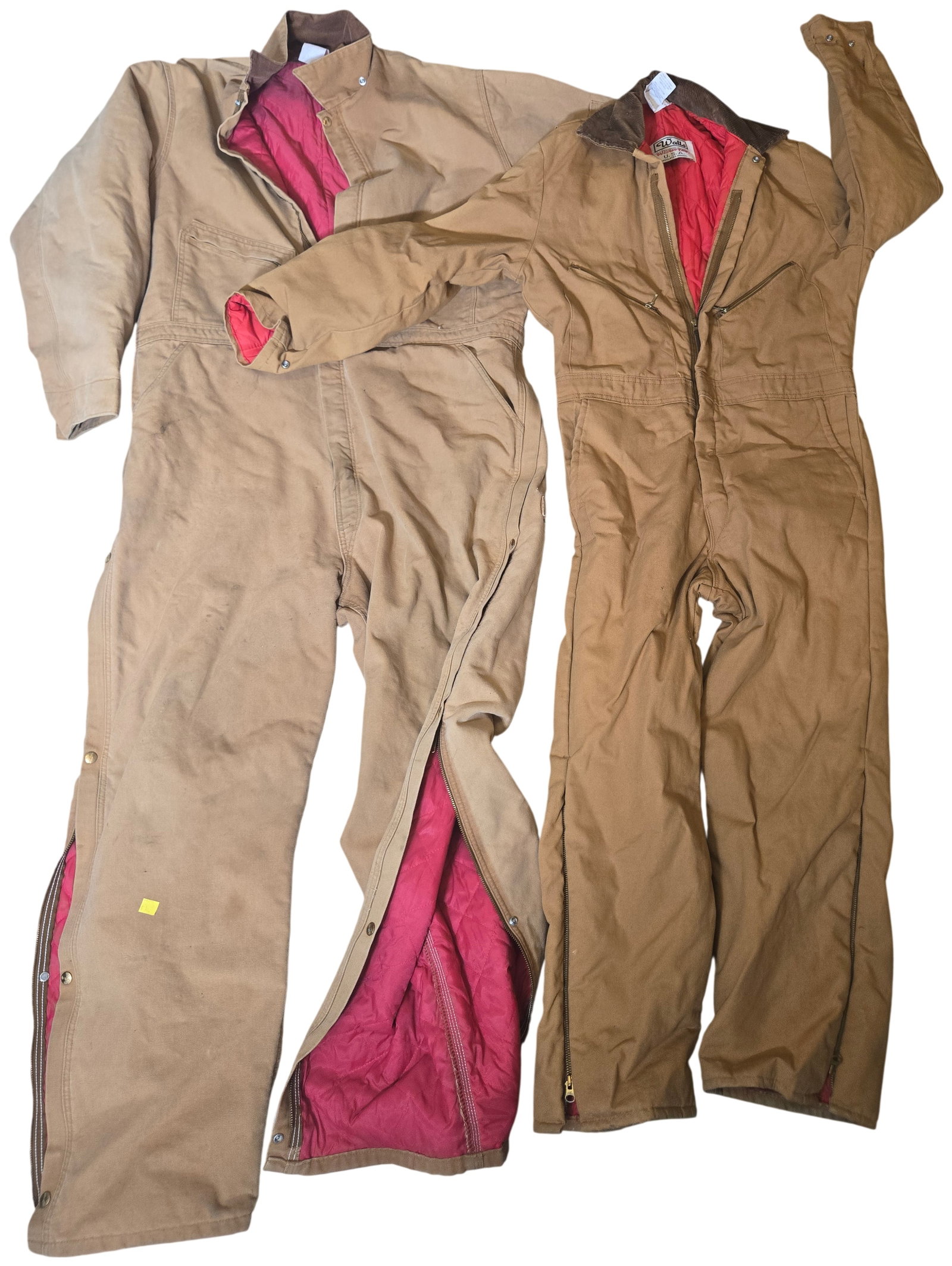 Two Pairs of Vintage Made in USA Insulated Work Coveralls by Carhartt and Walls Blizzard-Pruf: This lot consists of two pairs of vintage full-body insulated work coveralls manufactured by Carhartt and Walls. Both garments feature a heavyweight tan cotton duck canvas shell with a red quilted syn