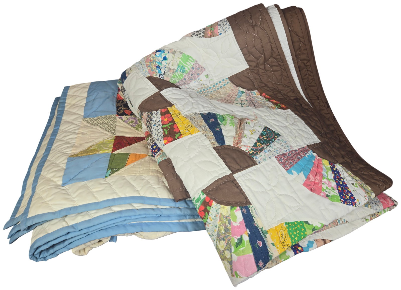 A Pair of Vintage Hand-Quilted Scrap Patchwork Quilts: This lot consists of two vintage American scrap quilts, both featuring hand-pieced construction and extensive hand-quilting. The first quilt is designed in the Grandmother's Fan block pattern, utilizi