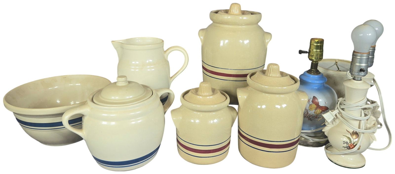 An Assortment of Roseville Stoneware Kitchenware and Decorative Table Lamps: This collection features glazed stoneware kitchenware from Roseville, Ohio, and three decorative table lamps. The stoneware group includes a three-piece graduated canister set produced by the Robinson