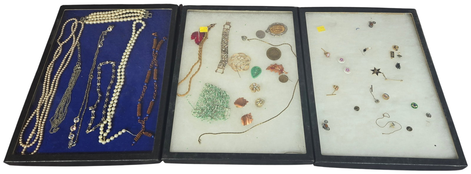 A Collection of Vintage Costume Jewelry and Commemorative Pins: Cases not included. This collection consists of costume and commemorative jewelry and accessories. One tray contains multiple strands of white imitation pearl necklaces, a coordinating three-strand im