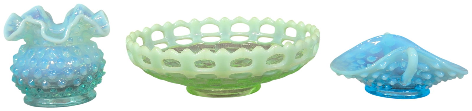 A Trio of Fenton Opalescent Glass Decorative Pieces: This lot comprises three pieces of American decorative opalescent glassware manufactured by Fenton Art Glass. The collection includes a blue opalescent hobnail vase featuring a crimped or ruffled rim 