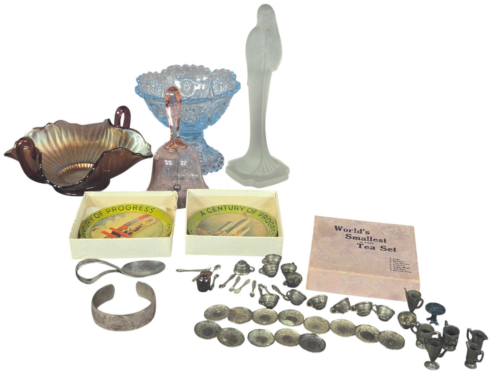 A Collection of Vintage Glassware and 1933 Chicago World's Fair Memorabilia: A collection of vintage decorative objects including a Northwood carnival glass two-handled bon bon bowl featuring a ruffled rim and ribbed interior. The group includes an Art Deco frosted glass figur