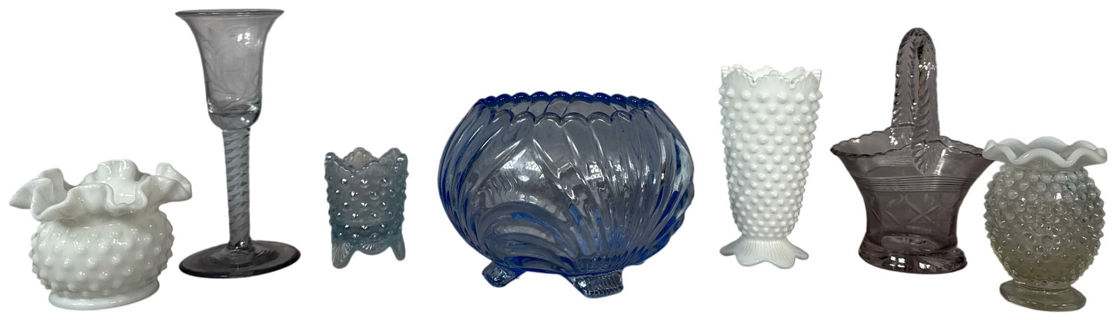 Seven Decorative Glass Items Including Fenton Hobnail and Opalescent Wares: This collection consists of seven decorative glass items, featuring several pieces of Fenton Art Glass in the popular hobnail pattern. The group includes an opaque white milk glass bowl with a pressed