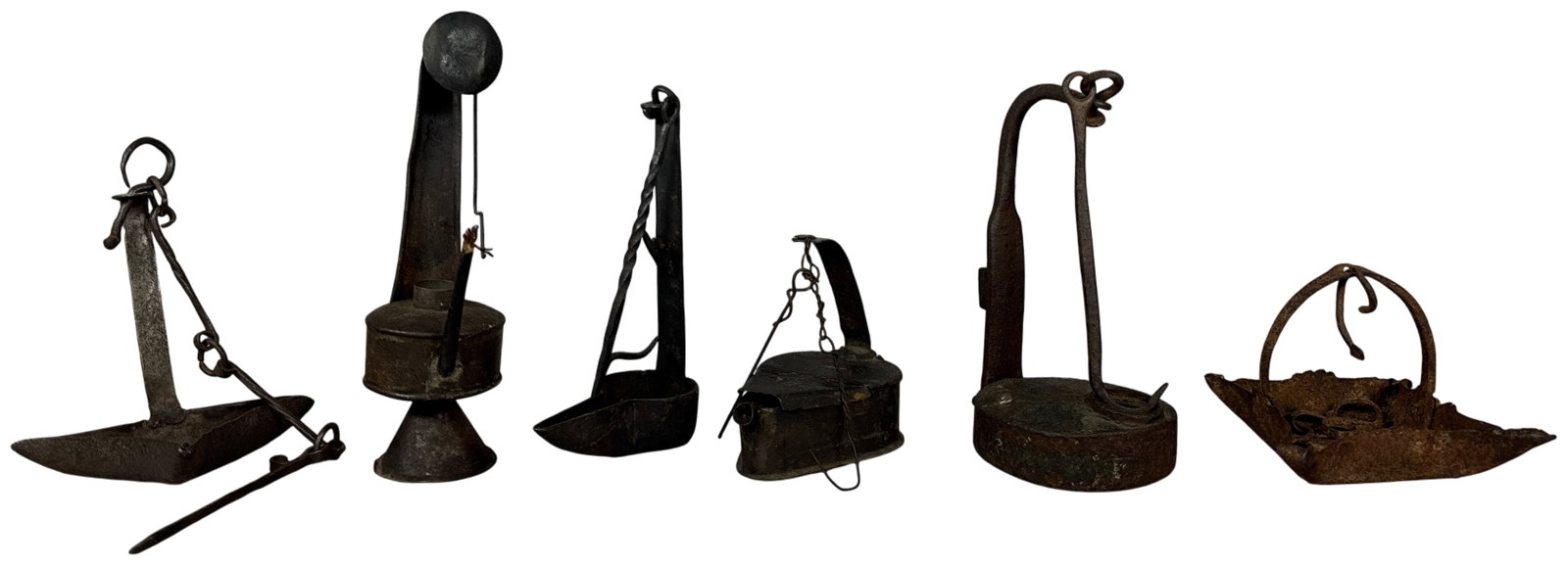 A Collection of Eighteenth and Nineteenth Century Wrought Iron and Tin Lighting Devices: An assortment of early American and European lighting implements primarily constructed from wrought iron and tinplate. The group features several distinct forms used for burning animal fat, whale oil,