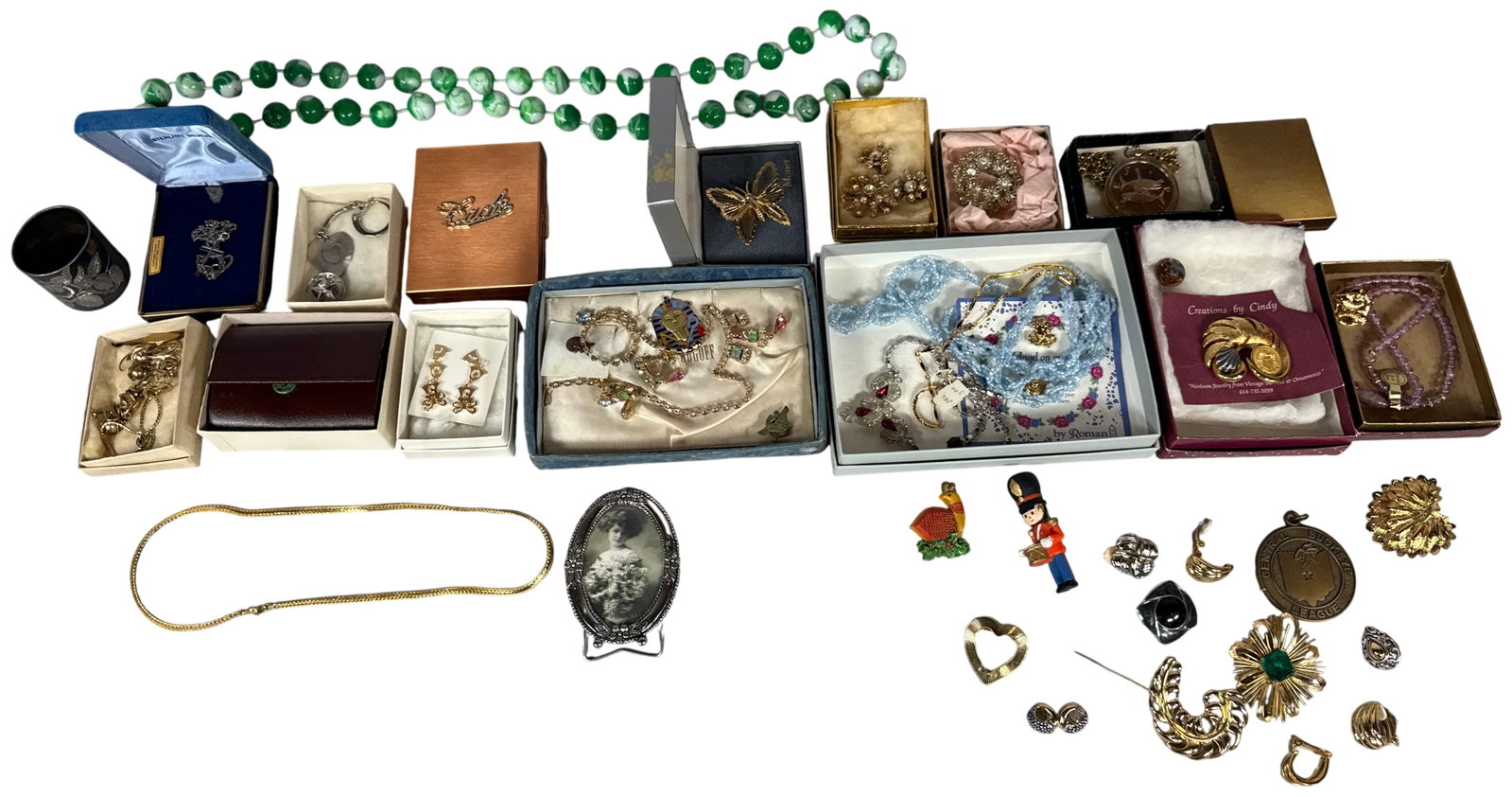 A Collection of Vintage and Contemporary Costume Jewelry and Small Collectibles Including Monet and: This is a diverse assortment of approximately 40 pieces of costume jewelry and small collectible items from various eras. The lot features several signed pieces, including a gold-toned wirework butter