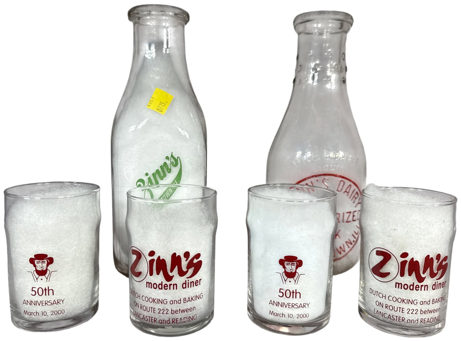 A Collection of Zinn's Dairy and Zinn's Modern Diner Glassware: This collection consists of two one-quart milk bottles from Zinn's Dairy in Beardstown, Illinois, and four commemorative glass tumblers from Zinn's Modern Diner formerly located in Denver, Pennsylvani