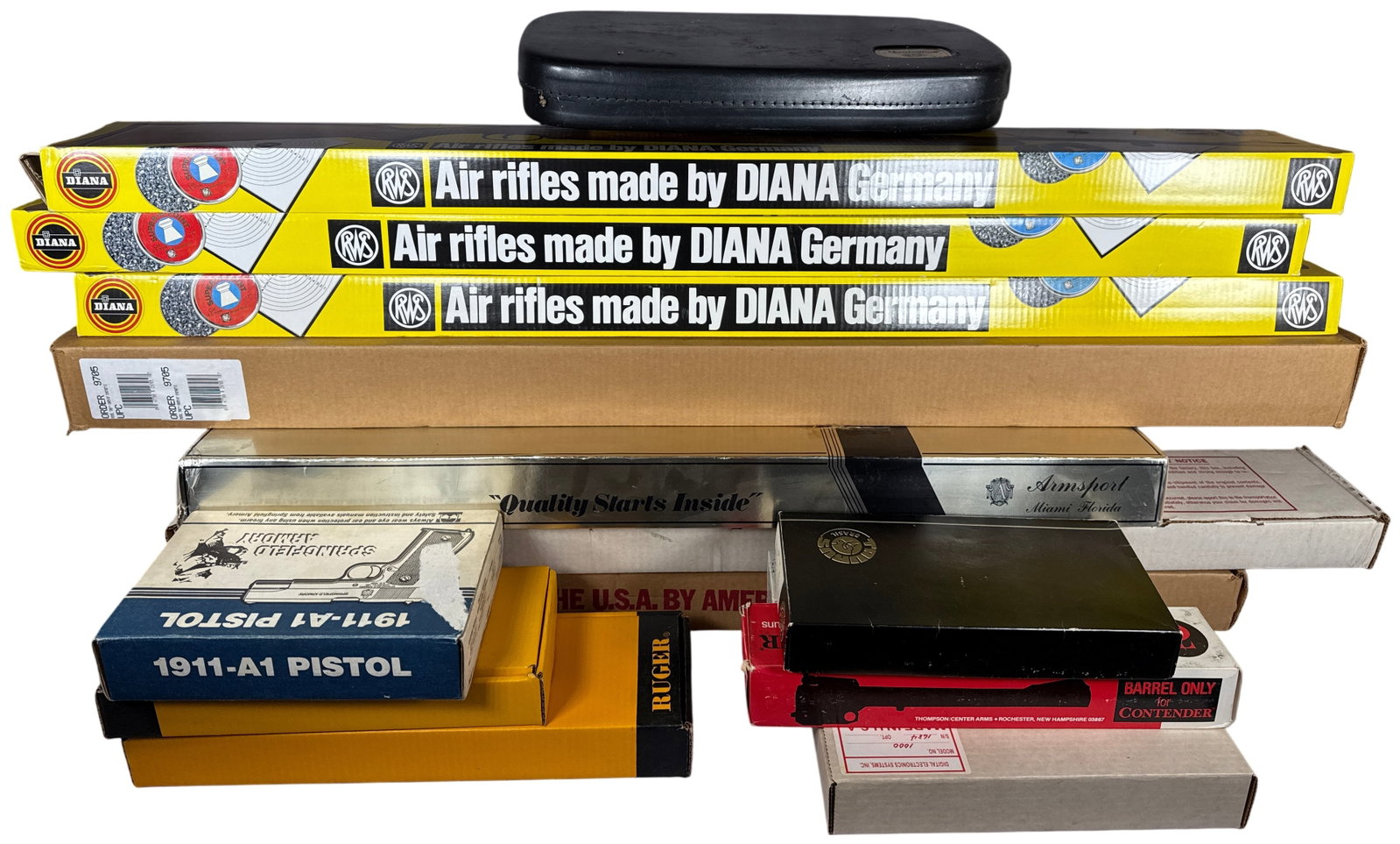 A Collection of 23 Pieces of Empty Original Factory Firearm Packaging and Cases: This collection consists of 23 pieces of empty original factory packaging for various firearms and air rifles including one black hard-sided plastic pistol case. The lot features a diverse range of ma