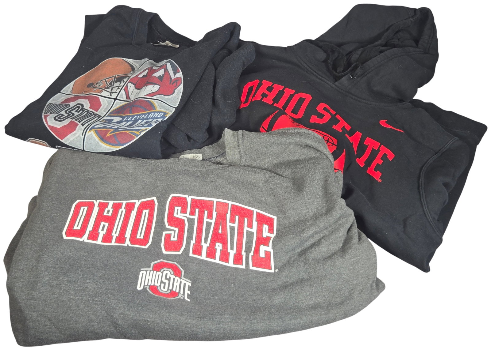 Three Ohio Collegiate and Professional Sports Team Sweatshirts: This lot consists of three sports-themed sweatshirts representing collegiate and professional teams from Ohio. The first item is a gray crewneck sweatshirt representing the Ohio State Buckeyes. The fr