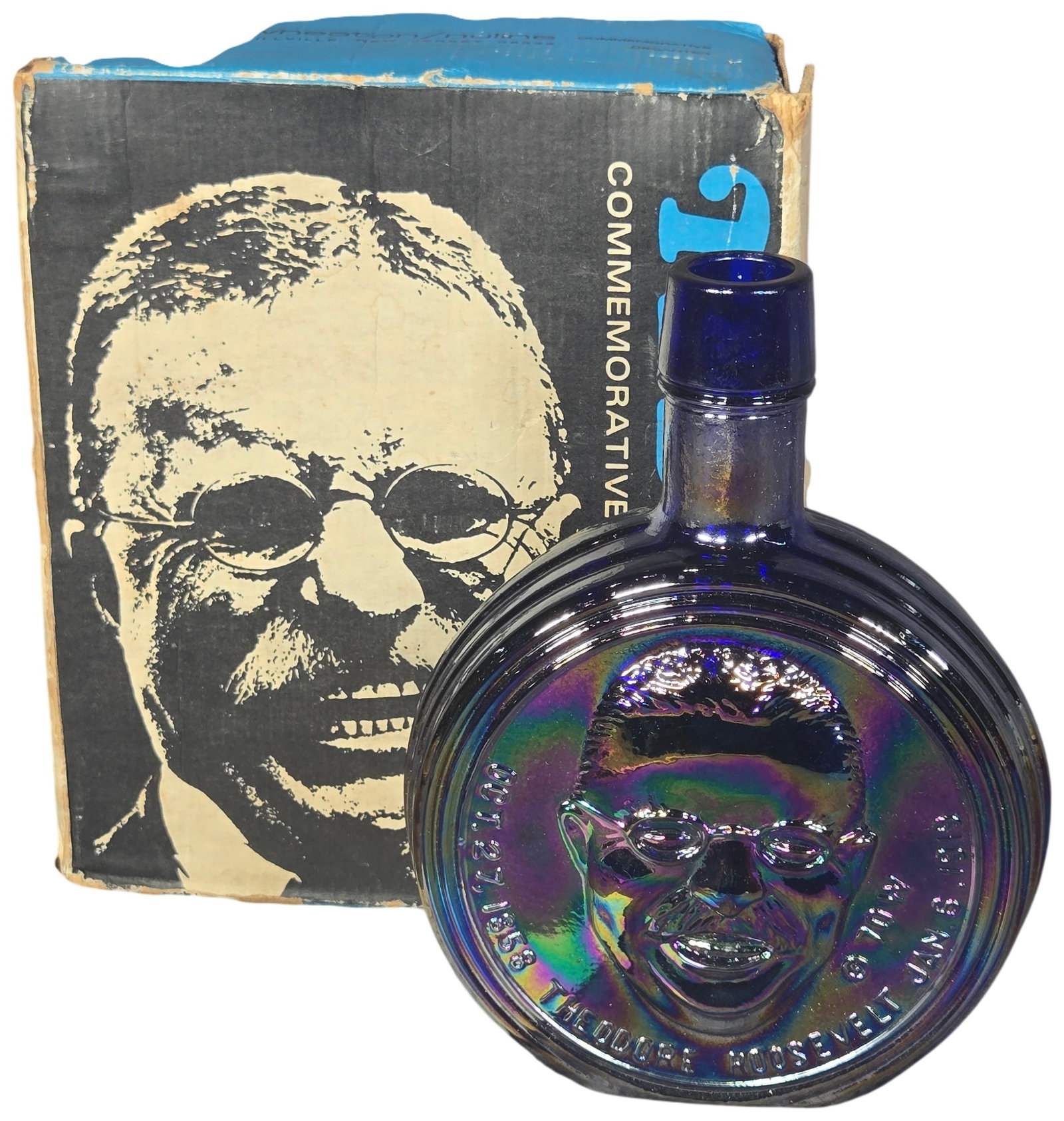 Wheaton Presidential Series Theodore Roosevelt Cobalt Blue Iridescent Glass Commemorative Decanter: This Wheaton/Nuline commemorative decanter from the Presidential Series features a bas-relief portrait of Theodore Roosevelt, the 26th President of the United States. The bottle is manufactured from c