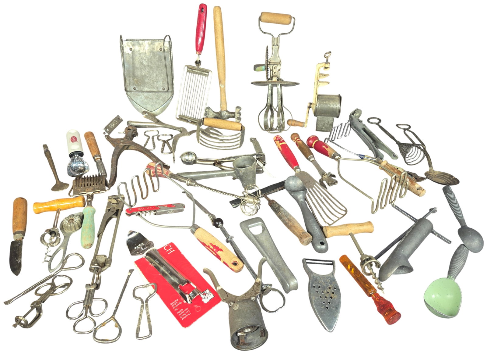 An Assortment of Vintage and Antique Kitchen Utensils and Gadgets including Ekco and Nuroll: An assortment of vintage and antique manual kitchen tools and gadgets, primarily constructed from pressed steel, cast iron, and aluminum. The collection features a variety of food preparation, serving
