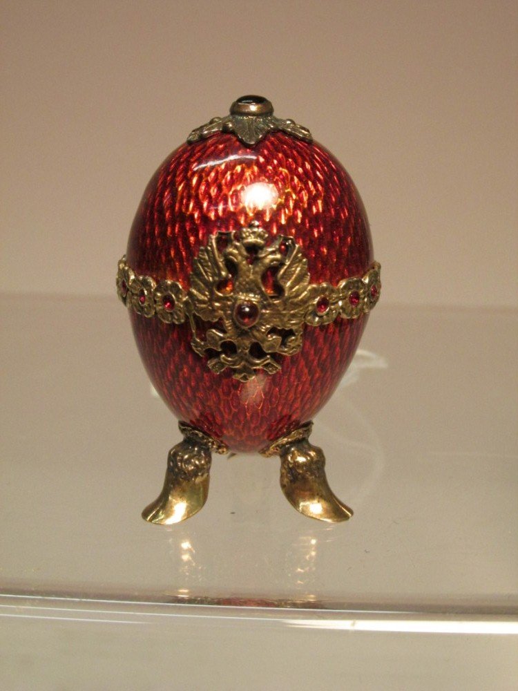Antique red enamel egg w/Russian Double Eagle crest.: Does not open. With a Sterling mark and two other unknown marks. Very nice. 1n 7/8" high. Shipping 7.50.