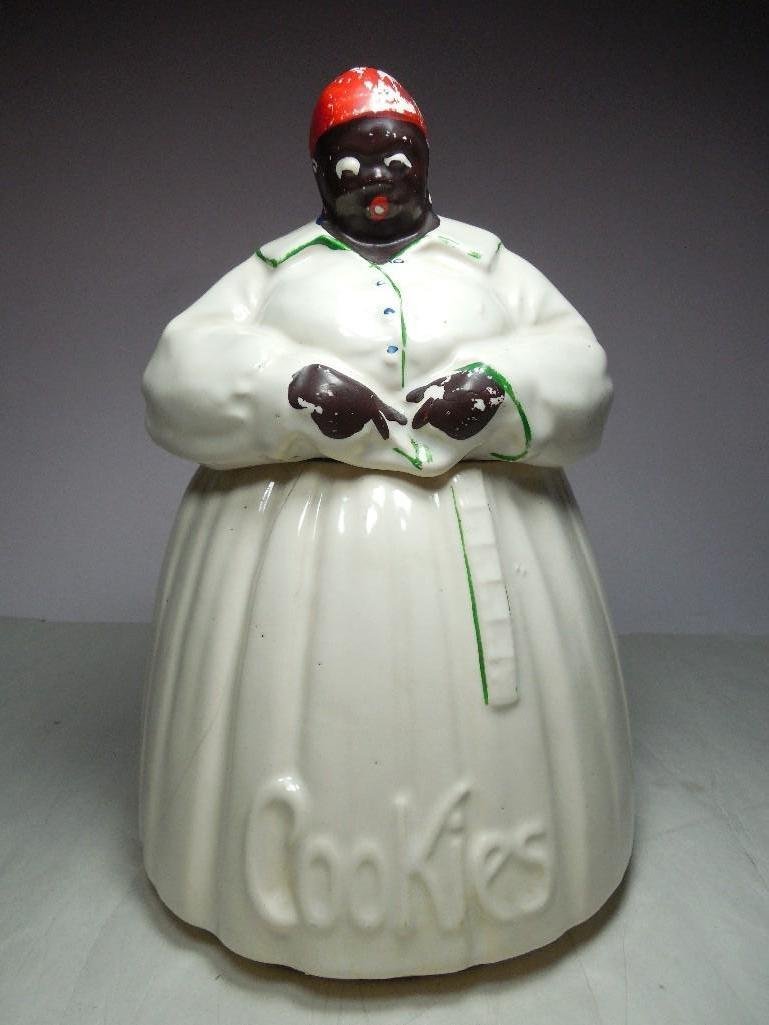 Vintage McCoy Black Americana Mammy Cookie Jar: Has hairline cracks from age on the bottom and one running up the side of the bottom half of the jar.See terms and conditions for shipping info.