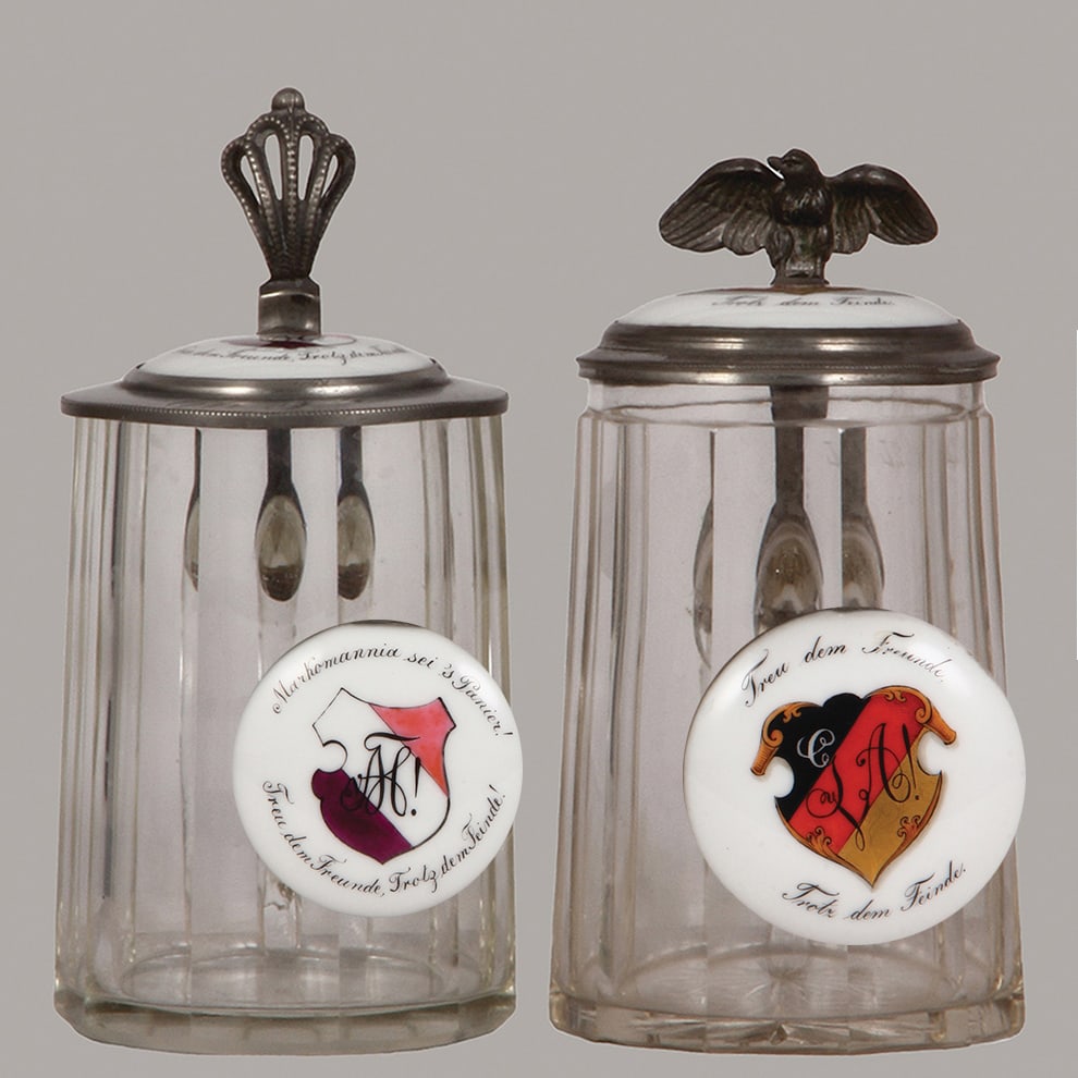Student steins (two), glass, 5L : Student steins (two), glass, 5L, blown, faceted, porcelain inlaid lids, Markomannia sei's Panier!, 1906, student society, mint; with, .5L, blown, faceted, porcelain inlaid lid: Damen Abteilung der G.V