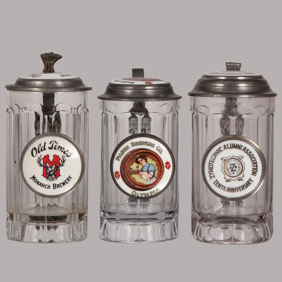Pre-prohibition brewery steins, three, .5L, glass : Pre-prohibition brewery steins, three, .5L, glass, porcelain inlaid lids: Old Times Monarch Brewery, tear & dent on lid, Pilsen Brewing Co. Olympia, mint, Zymotechnic Alumni Association 1901 - 1911, m