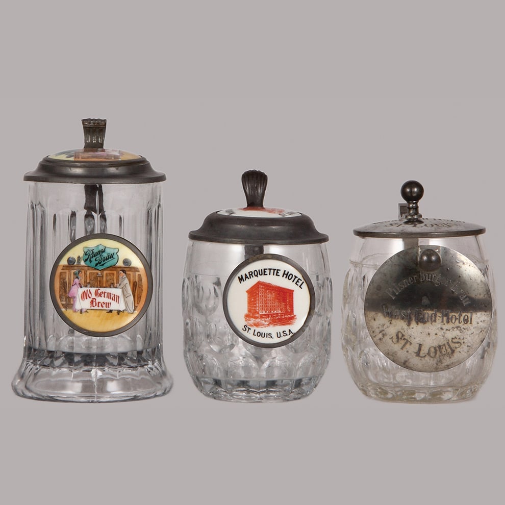 Pre-prohibition brewery steins, three, .5L, glass : Pre-prohibition brewery steins, three, .5L, glass, porcelain inlaid lids: Rienzl Bräu Old German Brew, Marquette Hotel St. Louis, U.S.A., pewter lid: Pilsner Bürger-Bräu West-End-Hotel St. Louis, a