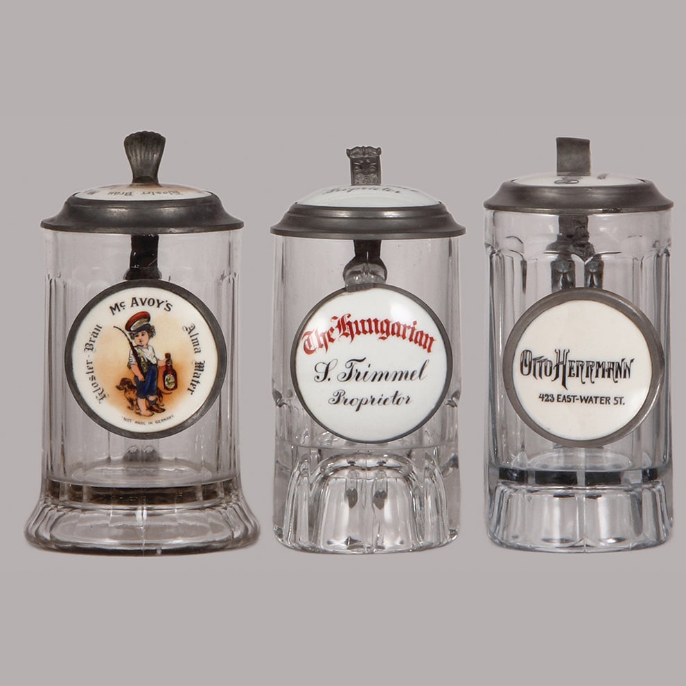 Pre-prohibition brewery steins, three, .5L, glass : Pre-prohibition brewery steins, three, .5L, glass, porcelain inlaid lids: McAvoy's Kloster-Bräu Alma Mater, The Hungarian L. Trimmel Proprietor, Otto Herrmann 435 East-Water St., all mint.
