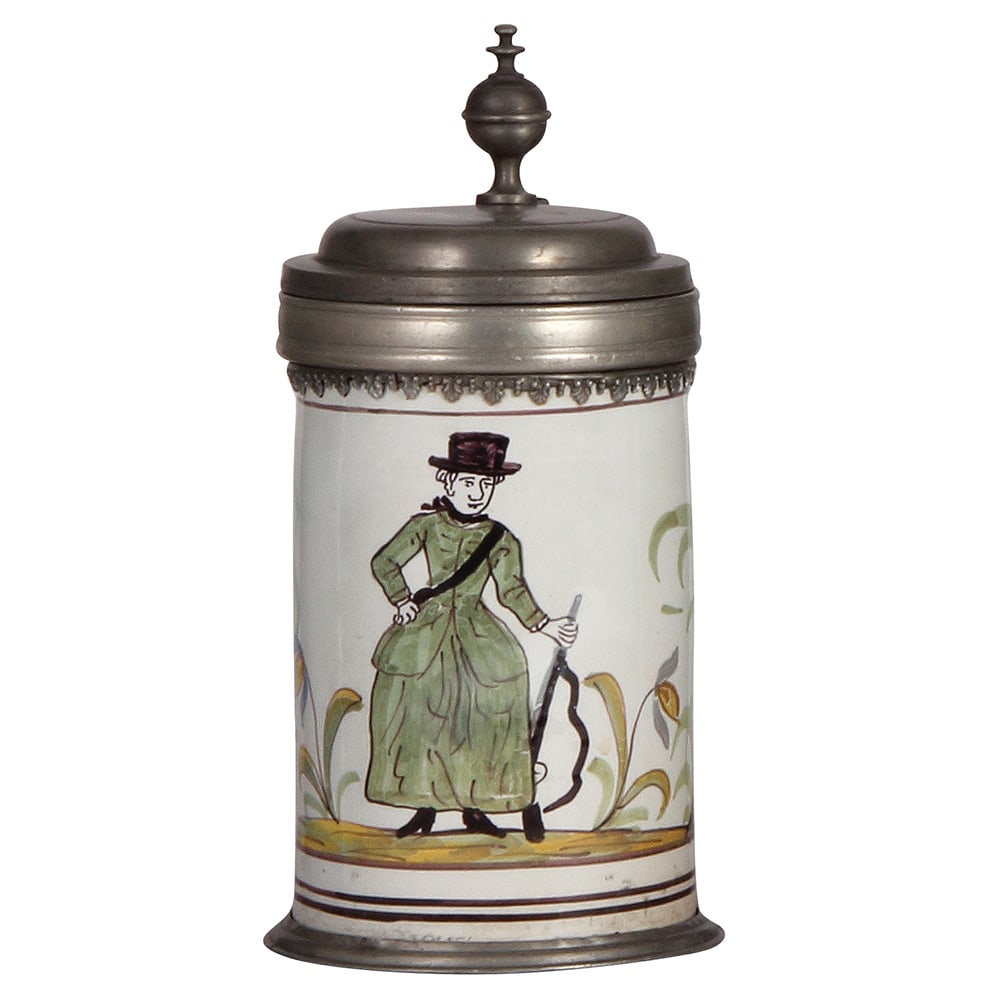 Faience stein, 9.5" ht., south German Walzenkrug.: Faience stein, 9.5" ht., south German Walzenkrug, rare scene of a woman with a rifle, pewter lid and footring, excellent repair of a 2" hairline on the side.