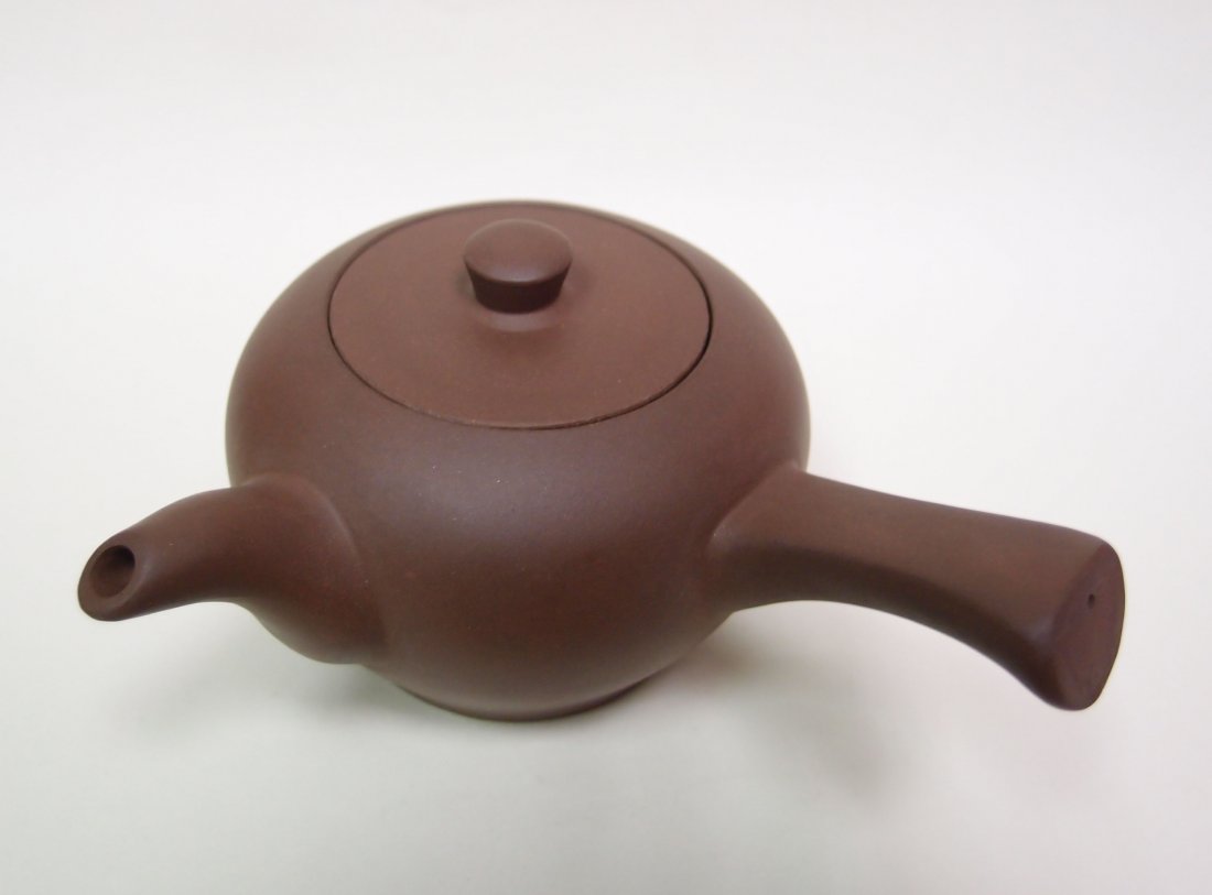 A Zisha Yixing Teapot: Size: 6.8cm high and 14cm long from spout to handle. This auction sale will be run faster than usual. In order not to miss anything you like, be reminded to place your bid promptly or place an absente