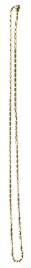 Collana in oro giallo formata da piccoli: Collana in oro giallo formata da piccoli barilotti, firmata Chimento Lunghezza cm 90 Totale grammi oro 53