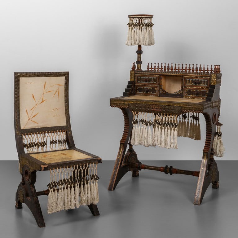 CARLO BUGATTI, inizi '900. Uno scrittoio ed: CARLO BUGATTI, inizi '900. Uno scrittoio ed una sedia. Intarsi realizzati con varie essenze di legno e peltro, rame sbalzato, decori manuali su pergamena, nappe di seta. Firma dell'autore sia sullo sc