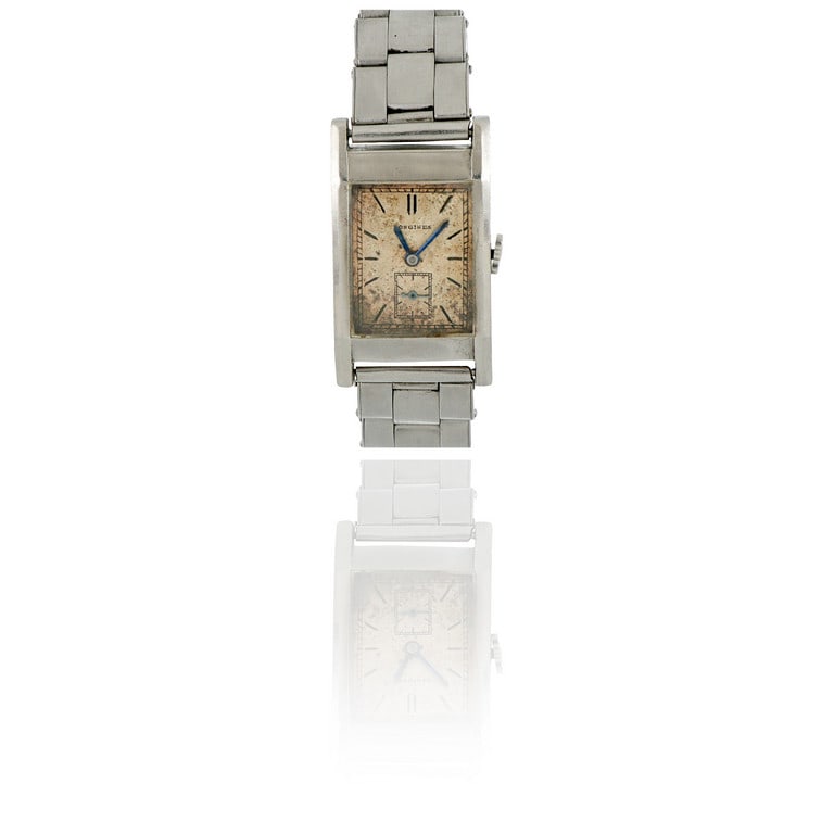 LONGINES - Orologio da uomo in acciaio con: LONGINES - Orologio da uomo in acciaio con bracciale non originale elastico. La forma rettangolare racchiude un movimento meccanico a carica manuale attualmente non funzionante. Quadrante da pulire, d