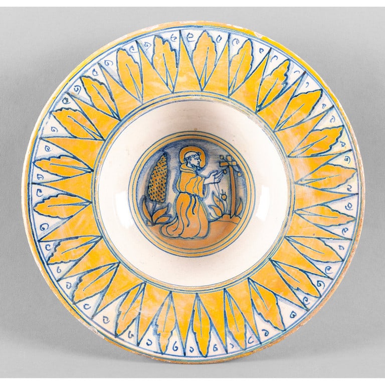 Piatto in maiolica policroma decorato a lustro,: Piatto in maiolica policroma decorato a lustro, al centro San Francesco in preghiera, Deruta sec.XX diam.cm.26, difetti