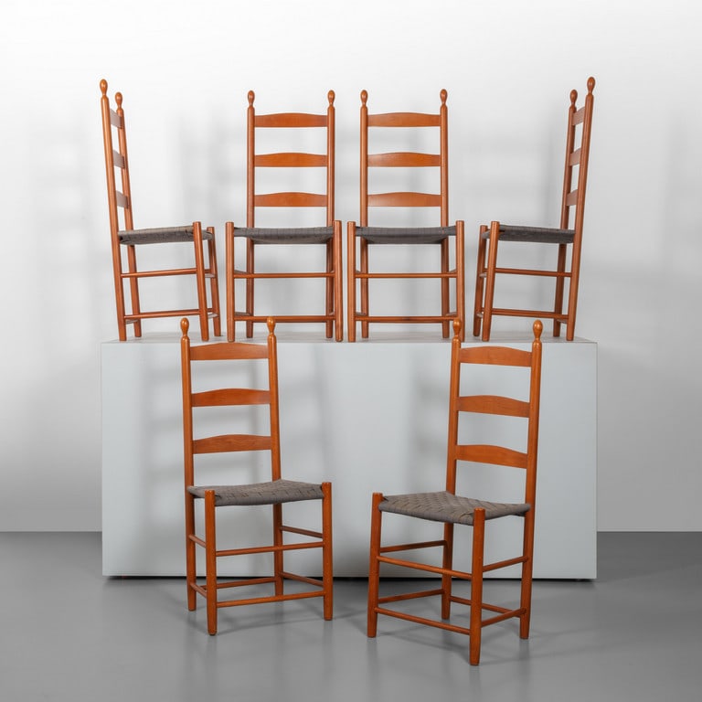 DE PADOVA (Editore), 1990. Sei sedie della: DE PADOVA (Editore), 1990. Sei sedie della serie 'Shakers'. Legno di ciliegio, sedute in cinghie di canapa intrecciata. Cm 108 (h) x 48 (l) x 42 (p). Letteratura: Catalogo Edizioni De Padova 1990 'Gli