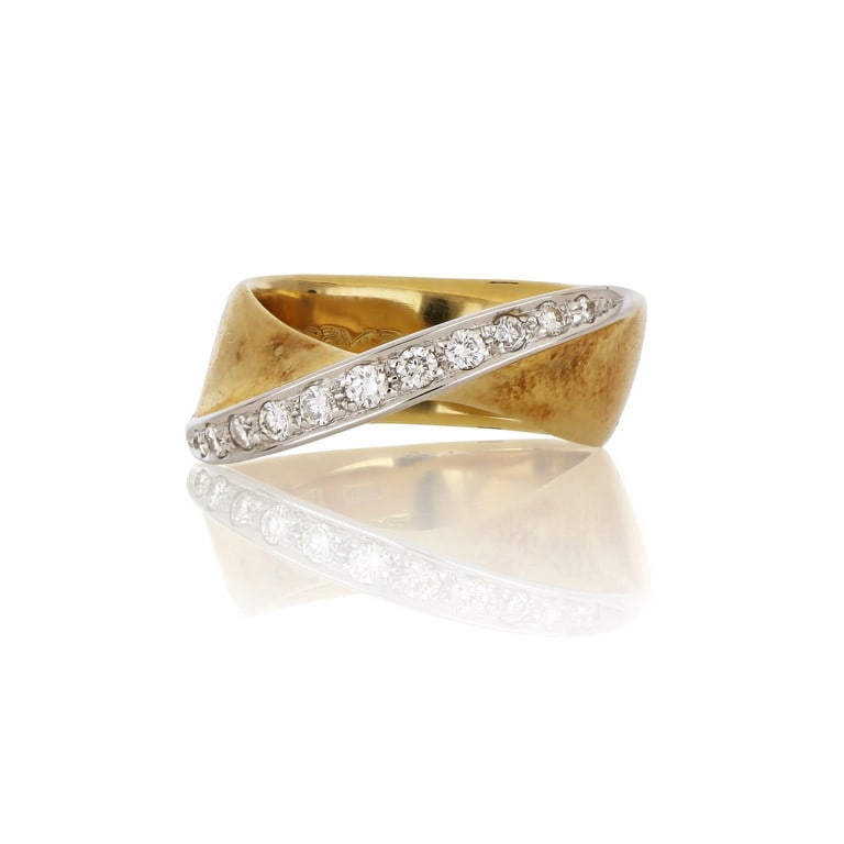 SCAVIA - Anello a fascia ritorta in oro giallo e: SCAVIA - Anello a fascia ritorta in oro giallo e bianco, al centro sormontato da un nastro di piccoli diamanti taglio brillante a decoro. Misura n. 12. Peso 8,37 g.