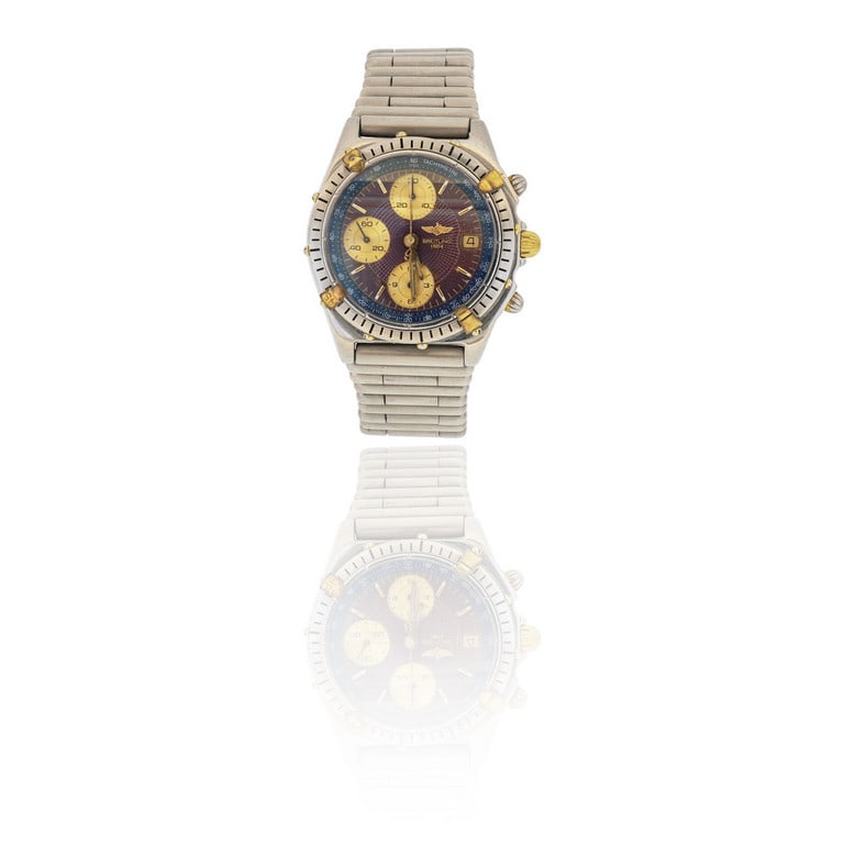 BREITLING - Orologio da uomo in acciaio e oro: BREITLING - Orologio da uomo in acciaio e oro giallo, modello "Cronomat", con bracciale originale, animato da movimento meccanico a carica automatica. Quadrante vinaccia con contatori oro, datario ad 