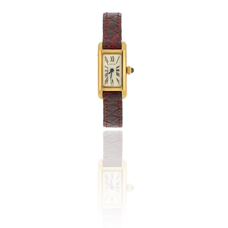 CARTIER - "Tank" in oro giallo e cinturino in: CARTIER - "Tank" in oro giallo e cinturino in pelle, fibbia originale, animato da movimento meccanico a carica manuale, quadrante in smalto e numeri romani. Dimensioni 3 x 1,5 cm. Peso 18,05 g.
