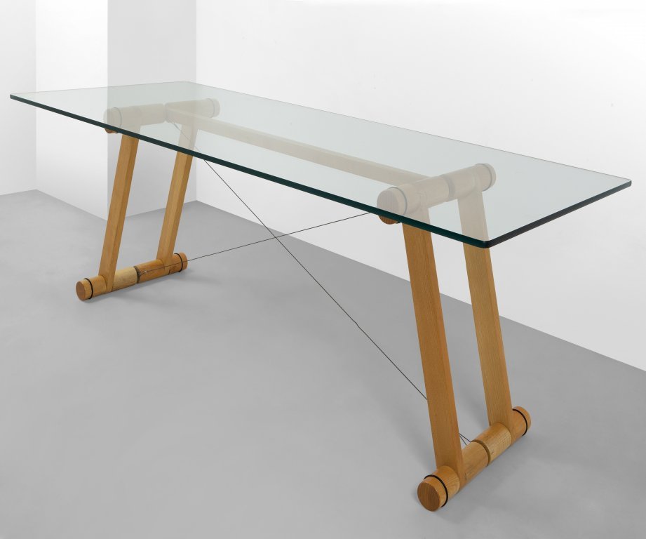 SUPERSTUDIO Un tavolo Â“TensoÂ” per: SUPERSTUDIO Un tavolo Â“TensoÂ” per GIOVANNETTI, 1975. Legno di frassino, cristallo, tiranti di acciaio. Cm 72 (h) x 200 x 80. A Â“Tenso dining table manufactured by GIOVANNETTI, 1975. Ash wo