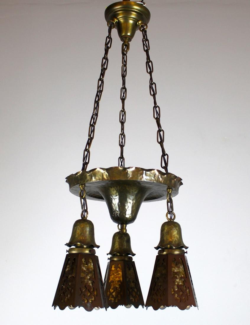 3 light hammered shower fixture: Petite 3 light Shower fixture with hammered brass finish. Fitted with three mica cut out shades. C. 1915. Meas: 31"L x 14"D