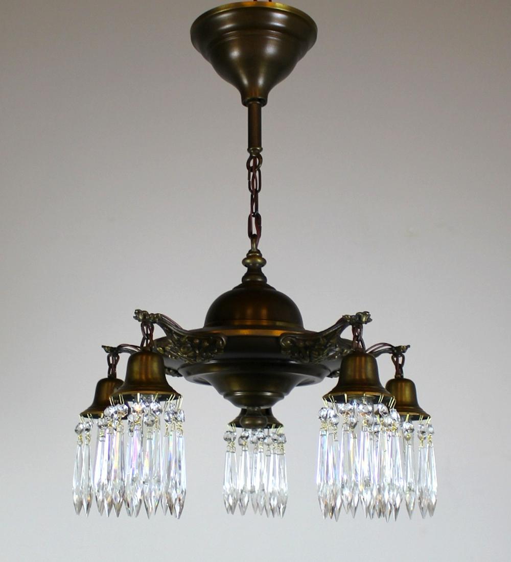 5 Light Pan finished with crystals: Lovely 5 light pan fixture with highlighted arm details, finished in an Antique Brass colour, and complemented with crystal holders. Meas: 27"L x 19"D