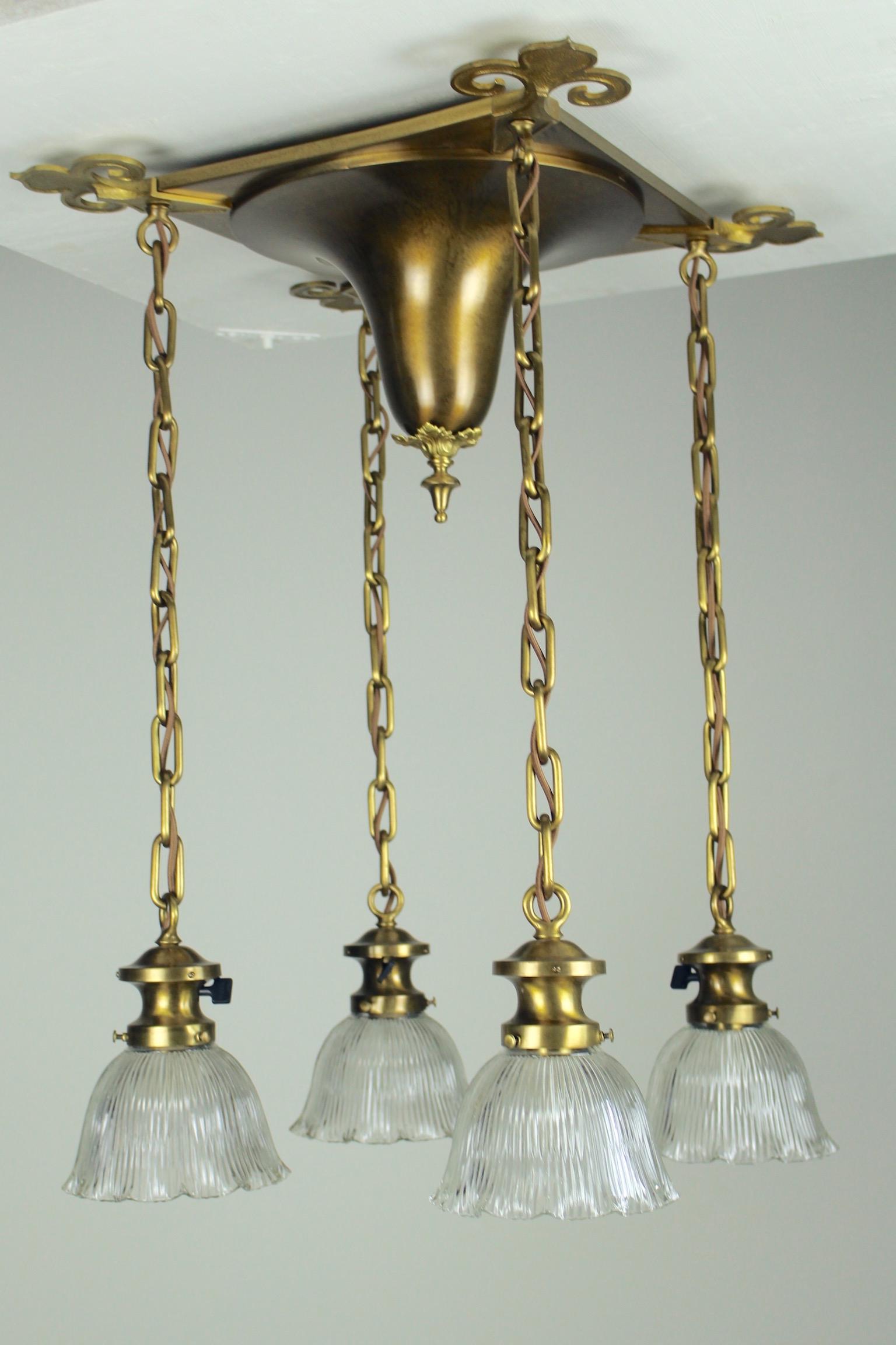 Handel FlushMount Fixture: Circa 1915 This is an absolutely gorgeous brass flushmount light fixture attributed to Handel. The square backplate is accented with dramatic cutout Fleurdelis motif on every corner. The fixture is fi
