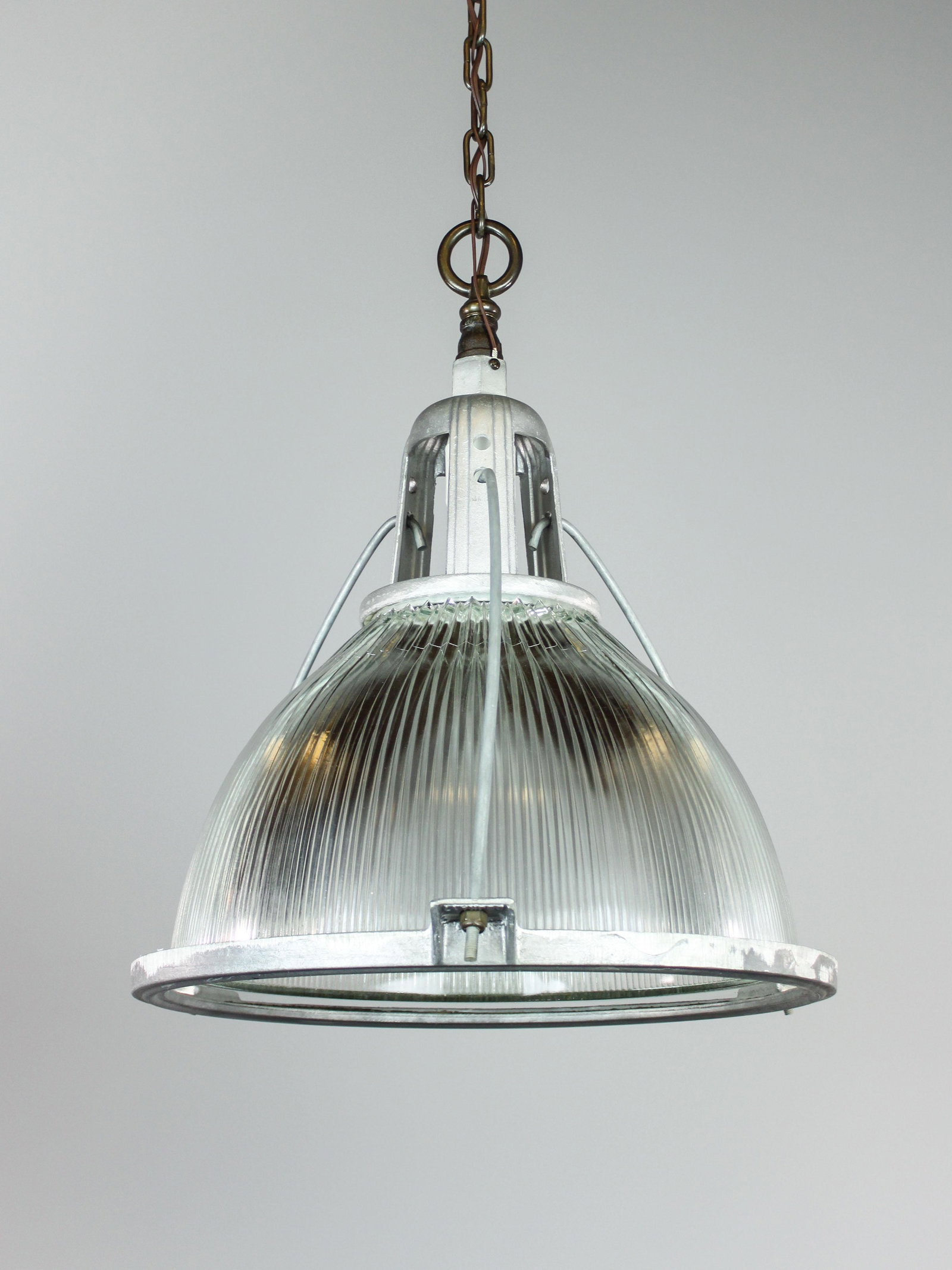 C. 1940 Oversized Industrial Holophane Pendant: Ca. 1940 Early American industrial holophane pendant fixture featuring heavy duty 300W module fitted with two removable reducers. Original finish and glass prismatic glass shade, rewired and ready to 