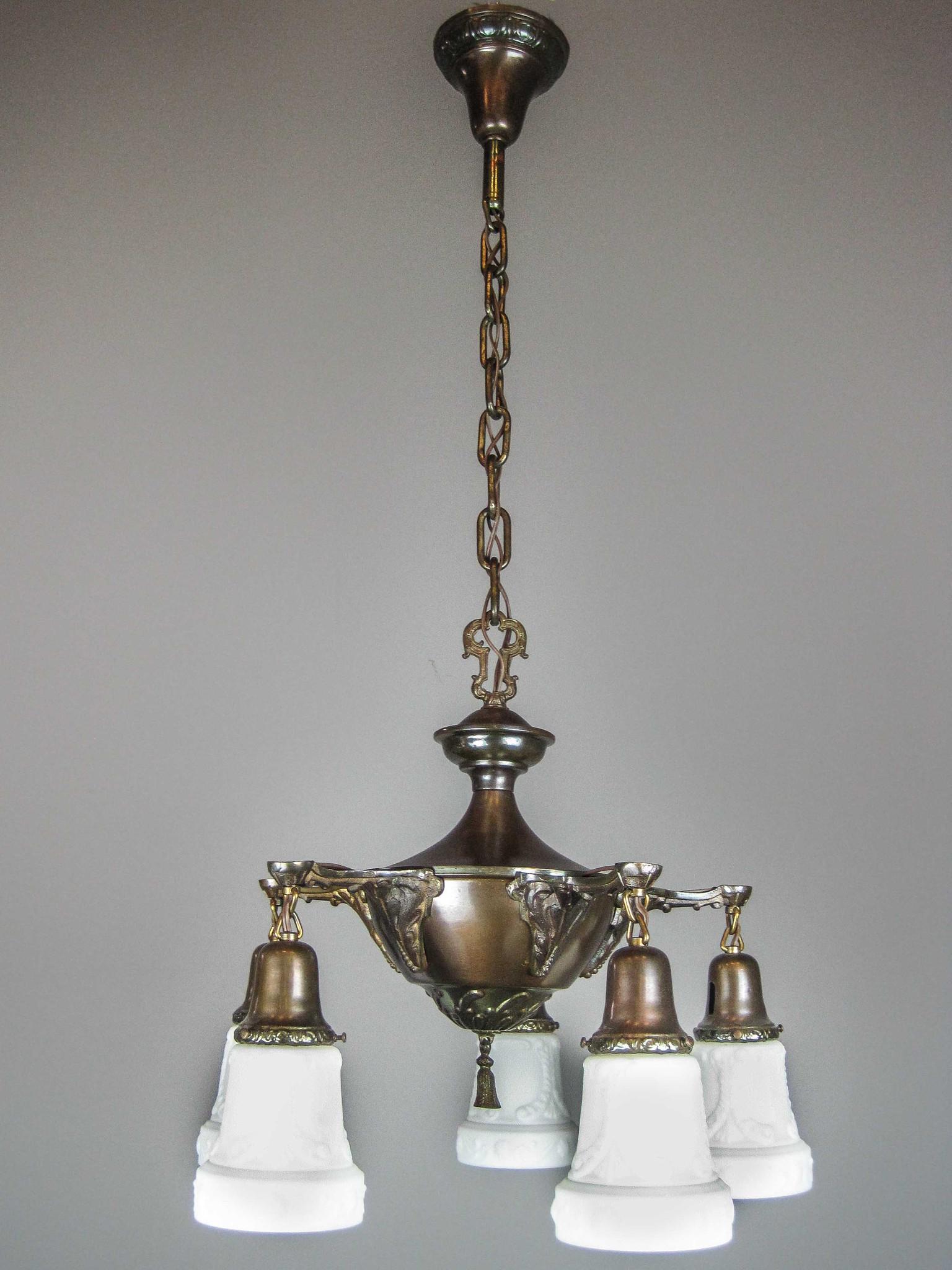 Original Pan Light Fixture (5Light): Ca. 1914 Cast brass and iron antique pan fixture with deeply embossed body and heavily detailed arms. Pattern matched canopy and shade holders which are fitted with periodcorrect "Milk Glass" shades. 