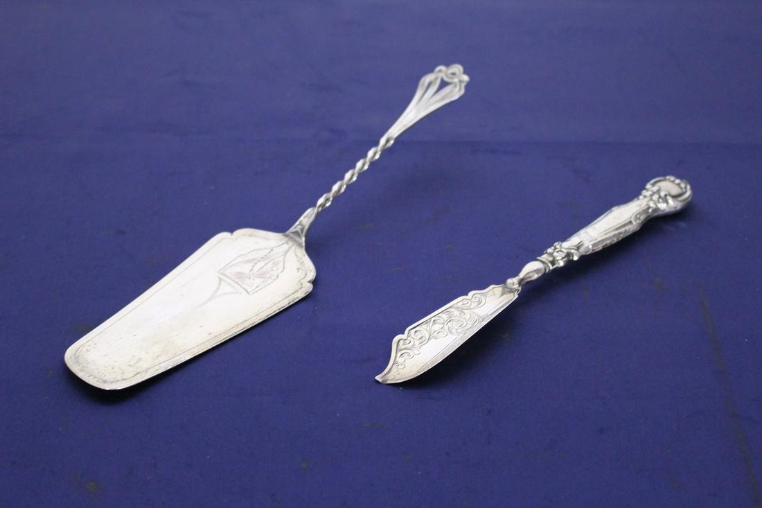 Two American Sterling Silver Serving Pieces: Two American Sterling Silver Utensils. One cake server and 1 knife. They measure 9" x 2.5" and 7" x 1" respectively.