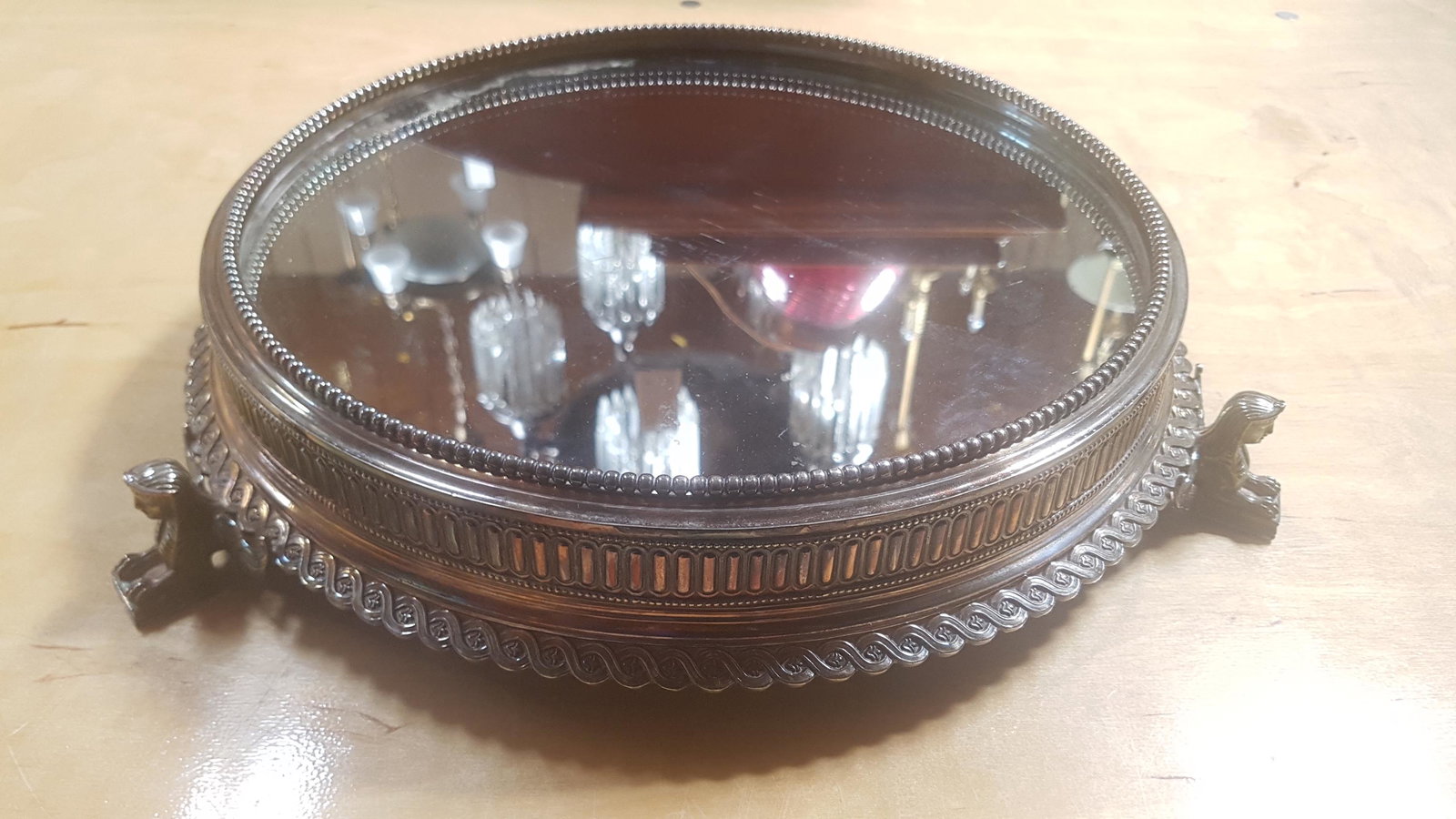 Egyptian Revival Silver Plate Platform with Mirror Top: Egyptian Revival Silver Plate Platform with Mirror Top. Fitted with 3 Sphinx form feet. Measures 16"D x 3"H.